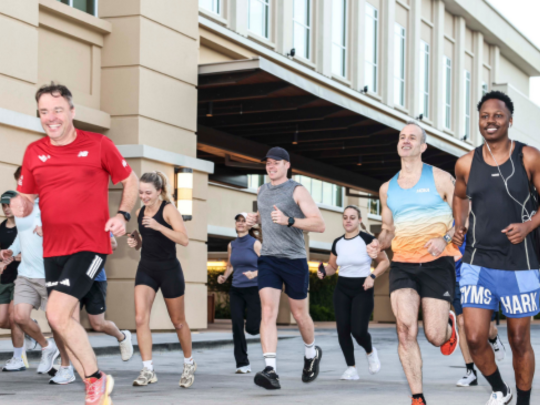 Group of Energy Transition Europe attendees running together during a morning 5K social event.