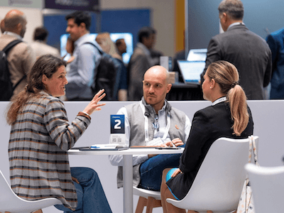 A small, intimate group of three professionals engaged in a lively, peer-to-peer discussion at a numbered roundtable at a Reuters Events conference, underscoring the collaborative environment where industry leaders exchange strategic ideas.