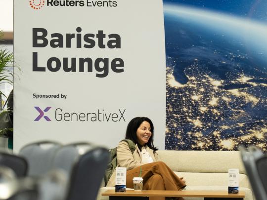 Single female professionals sat on sofa near event signage for the barista lounge at Reuters Events Pharma USA 2026