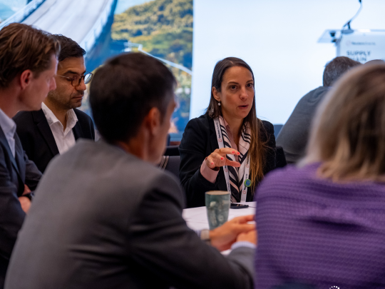Attendees seated at a Supply Chain Europe conference, listening attentively during a session in a bright, modern event space.
