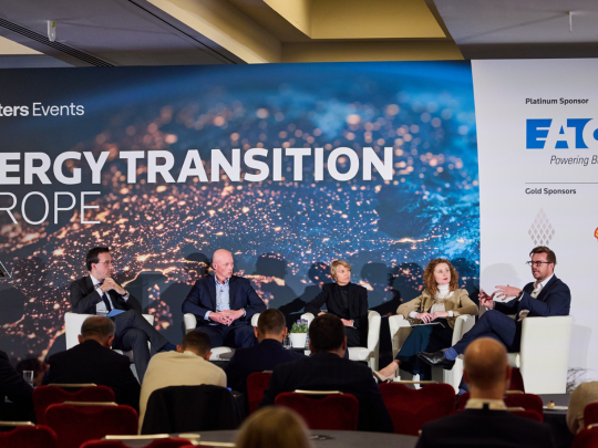 Five speakers taking part in a panel discussion on the Energy Transition Europe stage in front of an audience.