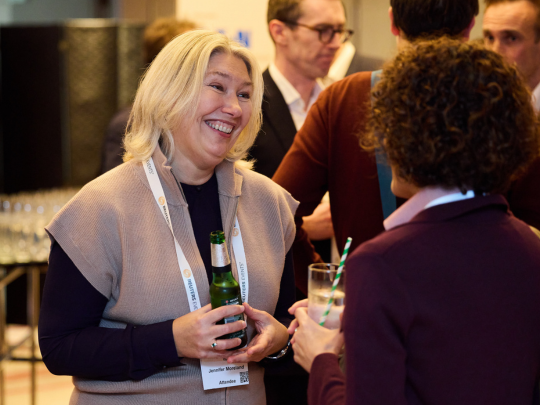 Energy Transition Europe attendees talking and holding drinks during a networking reception.
