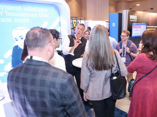 Insurance claims professionals networking and exchanging ideas at a sponsor exhibition stand during Connected Claims USA.
