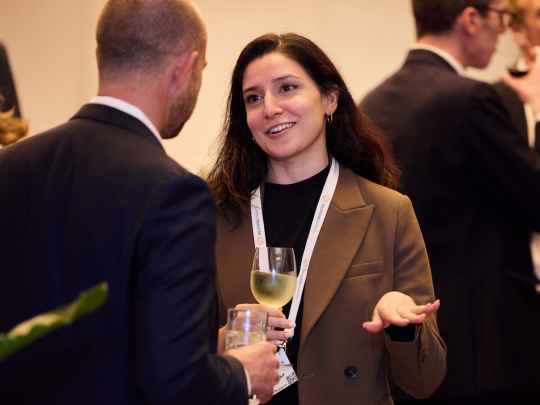Two Energy Transition Europe attendees talking over drinks at a networking event.
