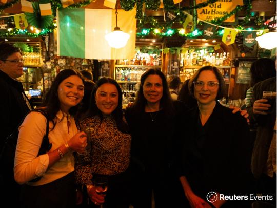 Four females professionals in a bar themed for St Patricks day at off site networking drinks at Reuters Events Pharma USA 2026