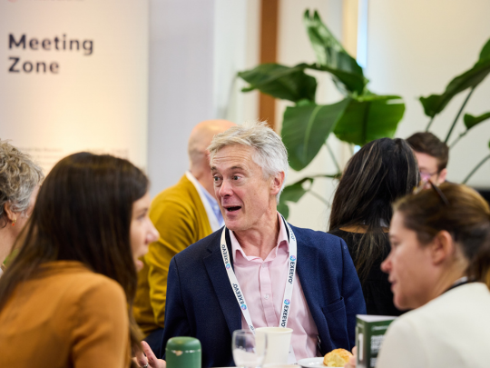 Attendees network over refreshments in the Reuters Pharma event meeting zone