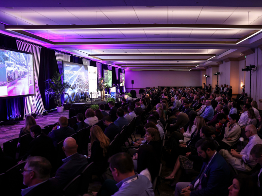 A packed auditorium of insurance professionals attending a keynote session at Connected Claims USA.