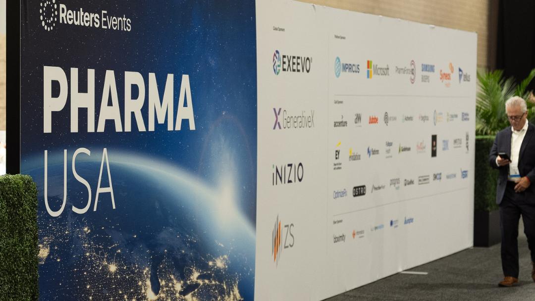 Large wall signage with the event key visual and a sponsor logo wall at Reuters Events Pharma USA 2026