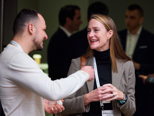 Two Energy Transition Europe delegates talking during a networking break.