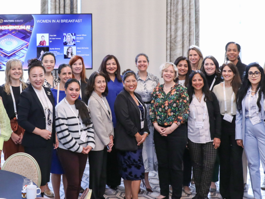 Attendees pose for a group photo at the Women in AI Breakfast at Momentum AI Austin.