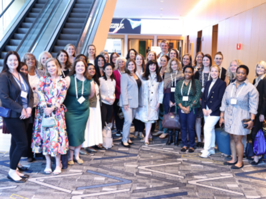 A group of Women in Claims attendees pose for a photo at Connected Claims USA.