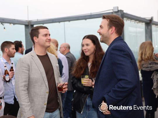 Senior insurance executives holding drinks and networking during an upscale outdoor rooftop reception at The Future of Insurance 2026 conference. The Reuters Events logo is visible in the bottom right corner.