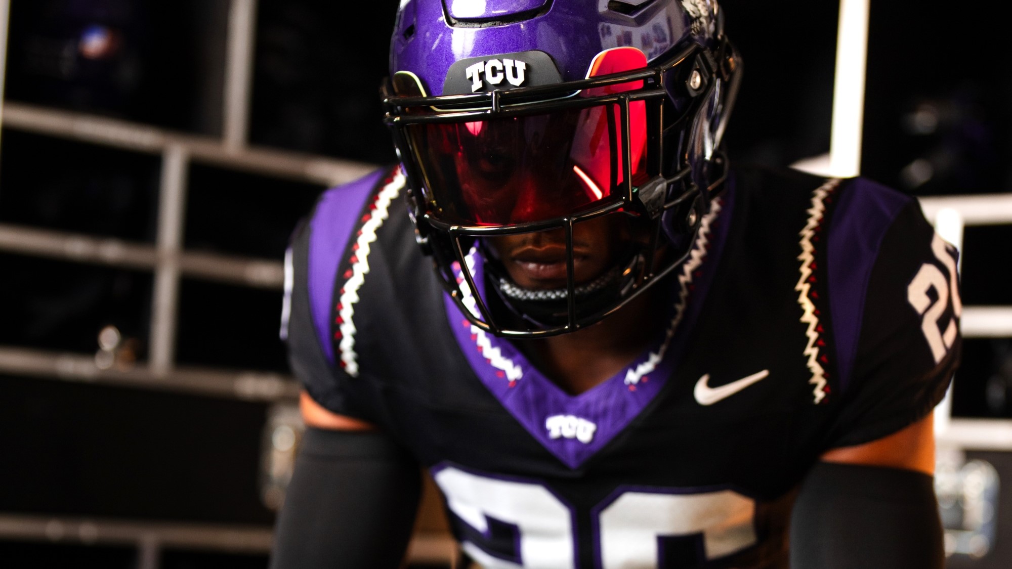 A picture of a TCU football player wearing a new black alternate jersey with horned frog accents on the shoulders and collar.