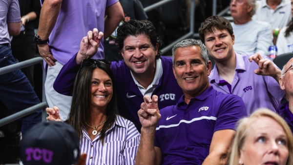 Director of Athletics Mike Buddi, wife Traci, and TCU Chancellor Daniel Pullin pose for a picture.