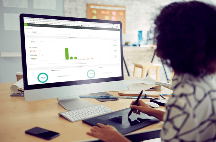 woman facing a computer screen with graphics